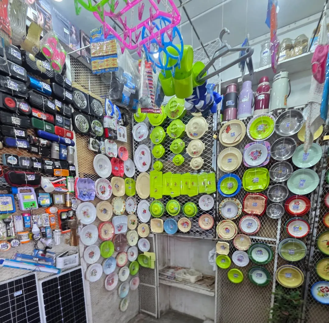 Inside Shaan Wholesalers: plates, bowls, speakers and solar panels on display