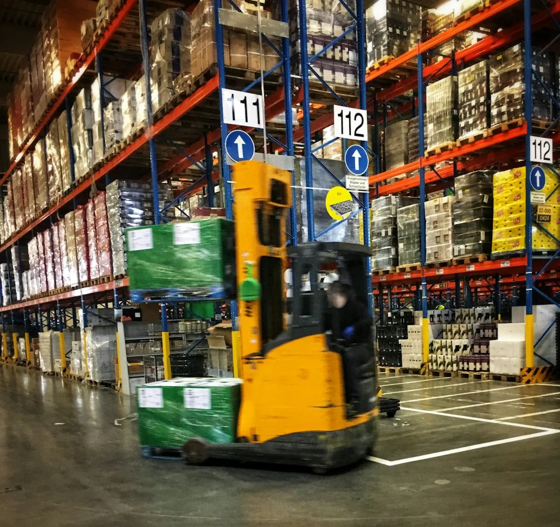 Forklift moving stock through a warehouse